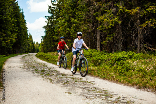 Healthy lifestyle - teenage girl and boy riding bicycles 