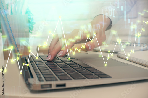 Multi exposure of woman hands typing on computer and forex chart hologram drawing. Stock market analysis concept.