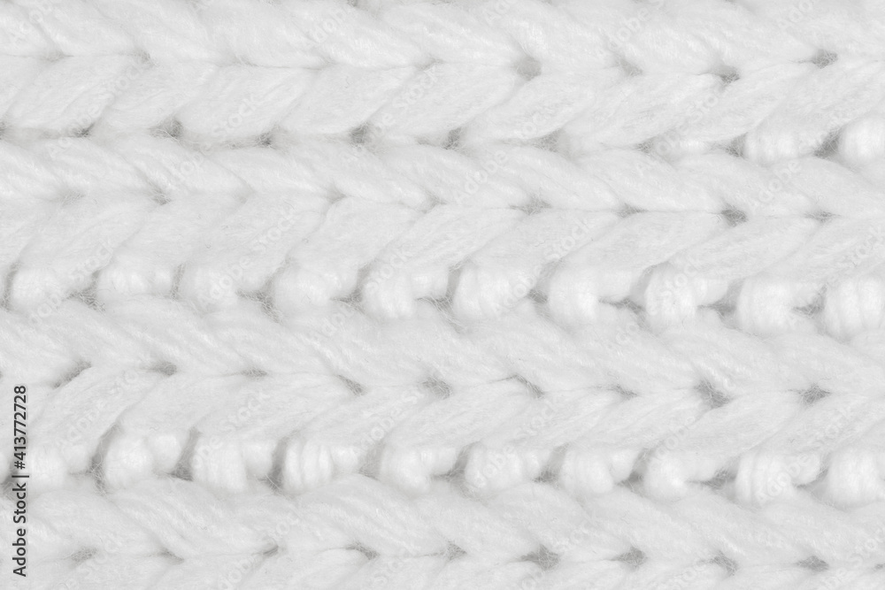 White natural texture of knitted wool textile material background. White crochet cotton fabric woven canvas texture. close up White natural texture of knitted wool textile material background. White crochet cotton fabric woven canvas texture. close up