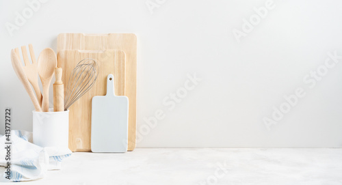 Fotografija Kitchen background mockup with teepot and cooking, baking utensils rolling pin, cutboard, bowls on the table on white background