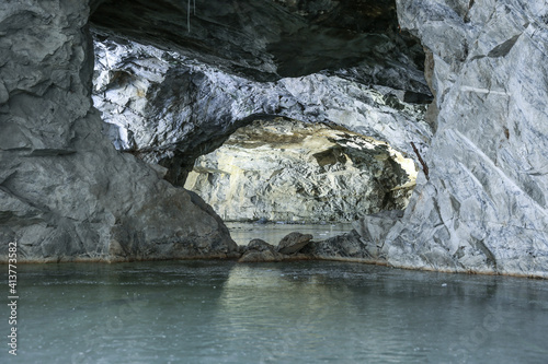 underground stone caves with frozen lake in winter 