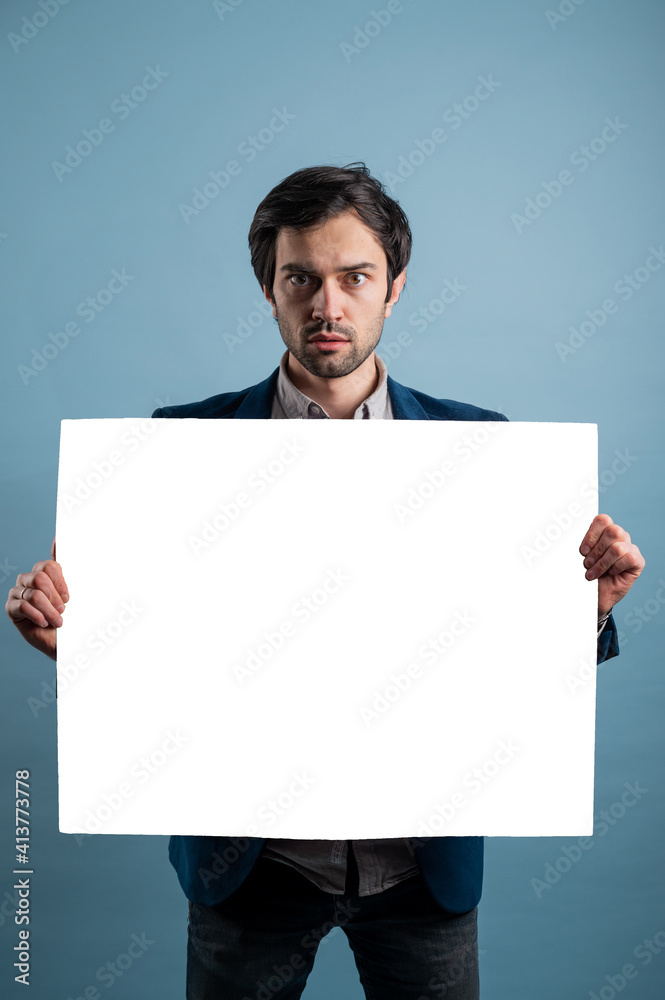 Surprised man holding white advertising banner Surprised man holding white advertising banner
