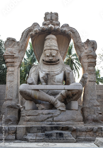 stone carved statute of the Hindu god Vishnu in his Narsimha avatar, that is half lion and half man in Hampi. photo