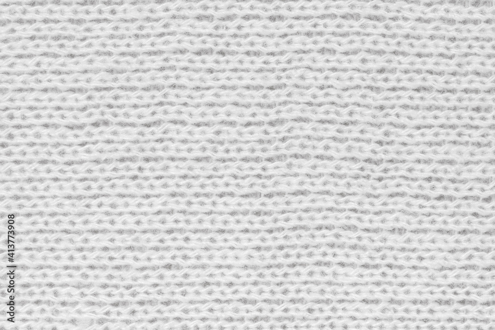 White natural texture of knitted wool textile material background. White crochet cotton fabric woven canvas texture. close up White natural texture of knitted wool textile material background. White crochet cotton fabric woven canvas texture. close up