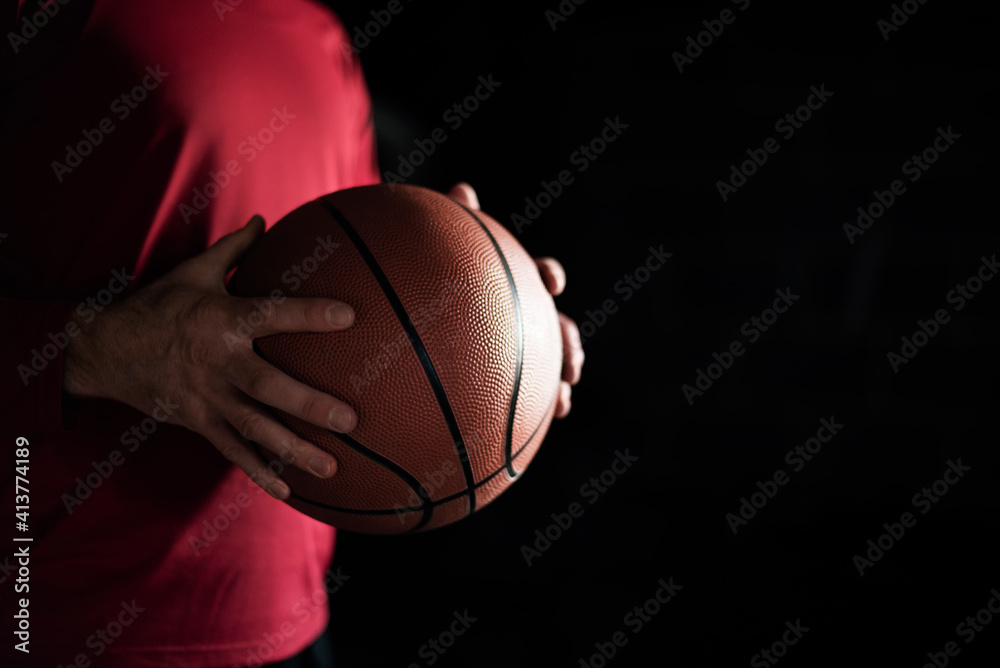 Midsection of man holding basketball at night Midsection of man holding basketball at night
