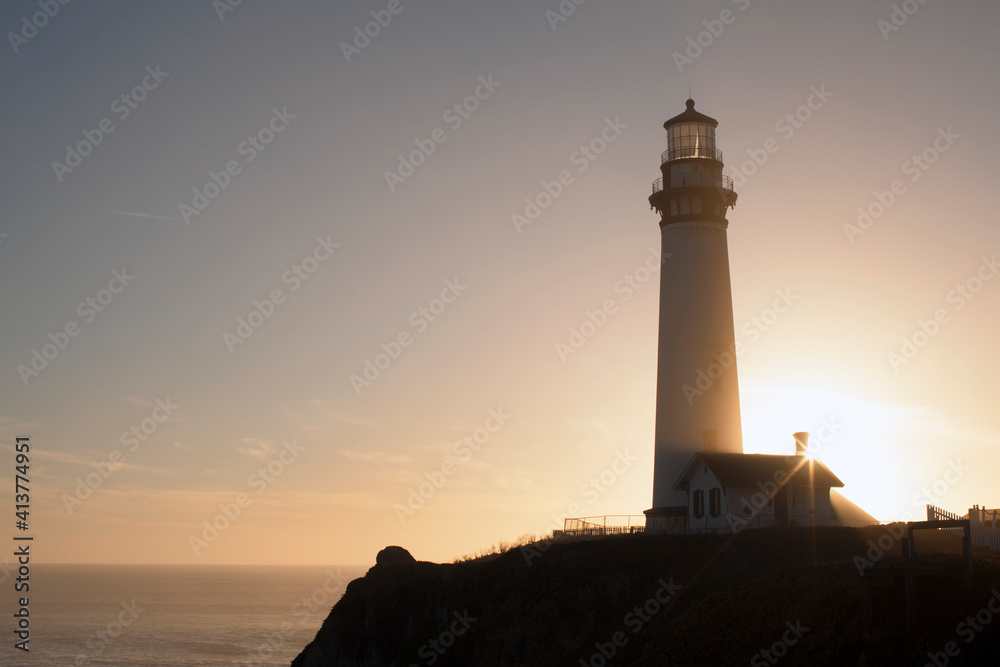 Low angle view of lighthouse on cliff against sky Low angle view of lighthouse on cliff against sky