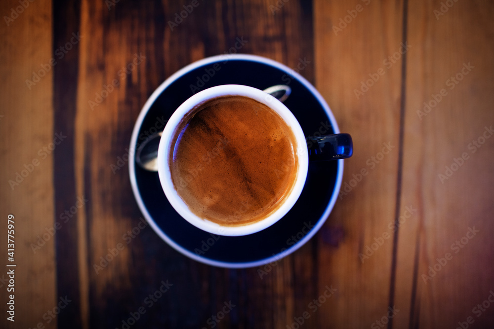 Overhead view of coffee cup on wooden table