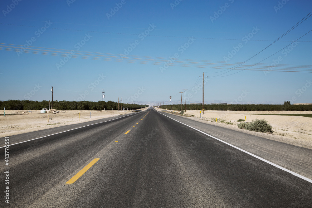 Highway on landscape against clear blue sky Highway on landscape against clear blue sky