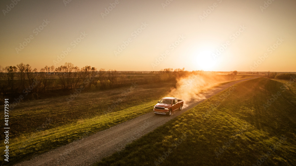 High angle view of pick-up truck moving on road amidst field
