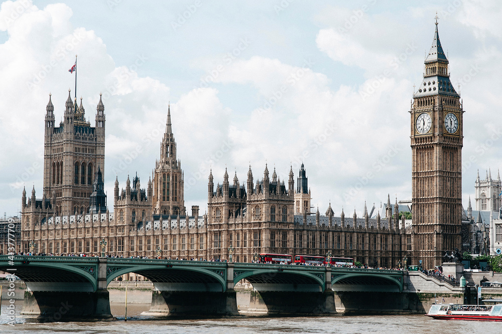 Westminster Bridge over Thames river by Big Ben against sky Westminster Bridge over Thames river by Big Ben against sky