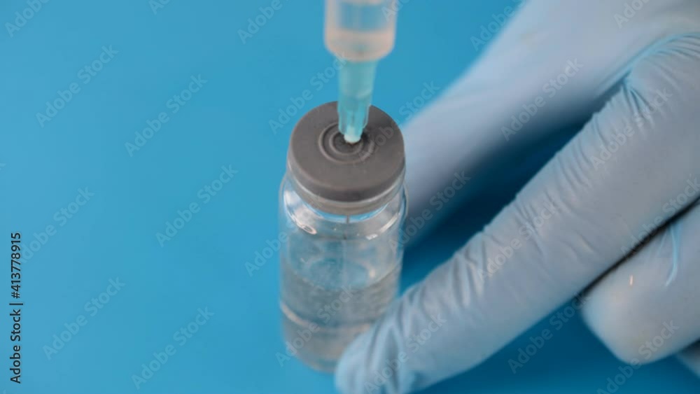 syringe and medicine vial prepare for injection on blue background syringe and medicine vial prepare for injection on blue background