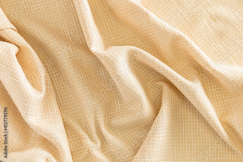 wrinkled yellow dense fabric with a relief