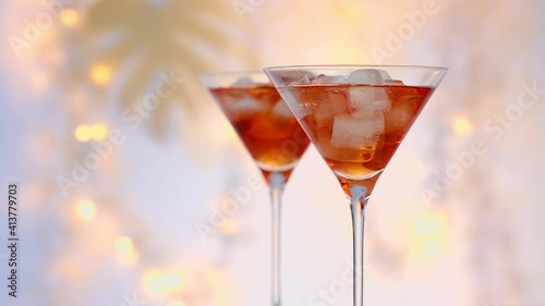 Wallpaper Mural two glasses of red summer cocktail with ice cubes close up, defocused  festive lights in background Torontodigital.ca