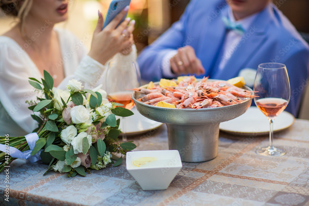 shrimp in ice with lemon on a table in a restaurant