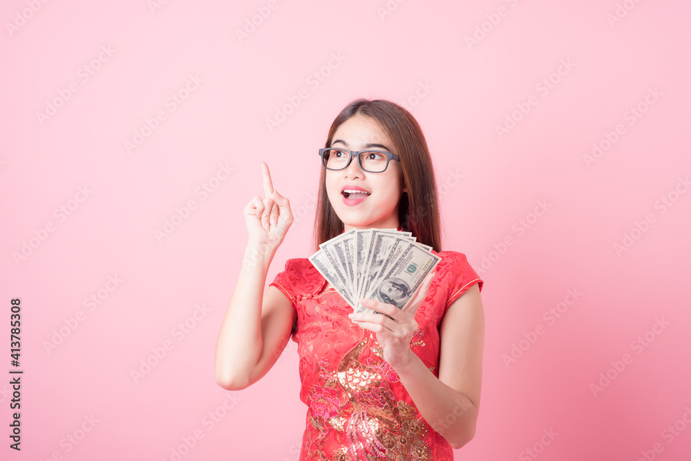 Action portrait beautiful Asian girl wearing Cheongsam red dress the celebration of something in a joyful and exuberant way. Festivities Chinese new year and Celebration concept Action portrait beautiful Asian girl wearing Cheongsam red dress the celebration of something in a joyful and exuberant way. Festivities Chinese new year and Celebration concept