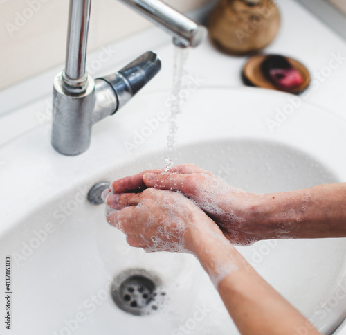 Washing hands rubbing with soap man