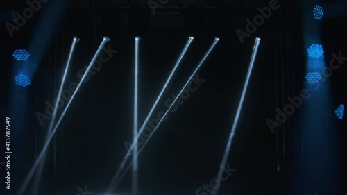 Colorful stage floodlights flashing during a live show concert. Lights equipment on disco party, moving and blinking bright lights in nightclub, illuminating space and creating relaxing atmosphere. photo