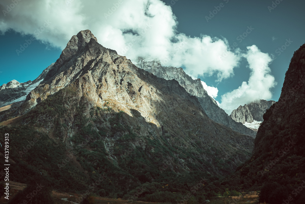Russia, Caucasus, Dombay, Dombay-Ulgen mountain illuminated by the setting sun Russia, Caucasus, Dombay, Dombay-Ulgen mountain illuminated by the setting sun