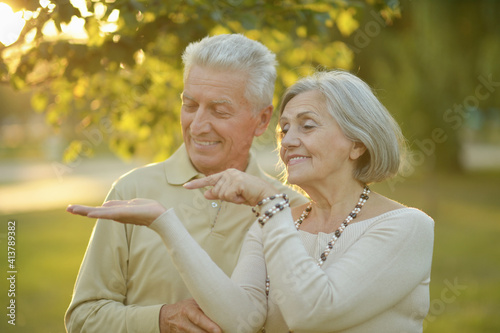 Wallpaper Mural  senior couple in the park showing something Torontodigital.ca
