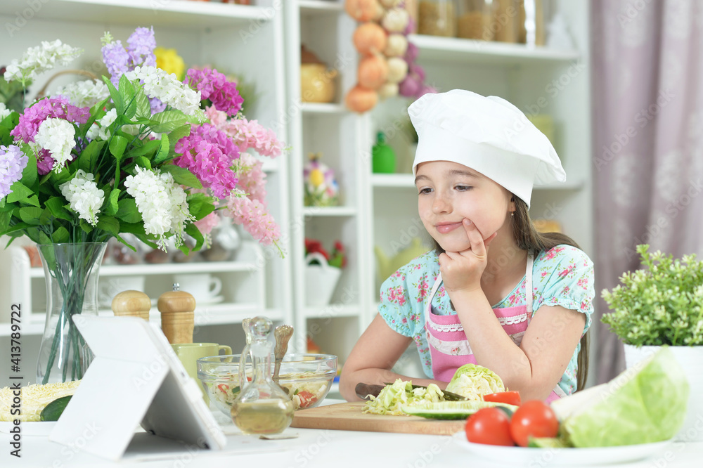 Cute girl preparing delicious fresh salad in kitchen Cute girl preparing delicious fresh salad in kitchen