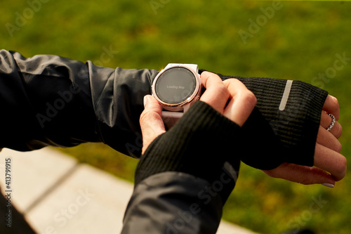 A close up of a woman's hand interacting with her fitness watch. photo