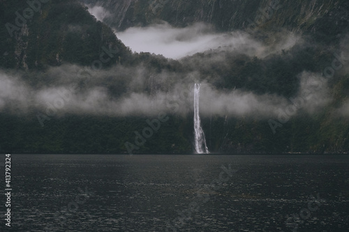 Scenic view of waterfall and mountains at Milford Sound, New Zealand photo