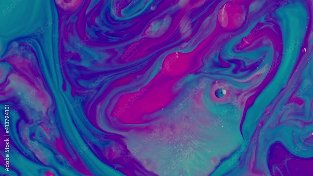 Close-up bright pink and turquoise oil paints slowly blend together Close-up bright pink and turquoise oil paints slowly blend together