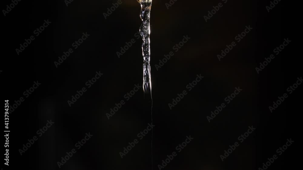Time lapse sequence of a growing icicle in front of a black background