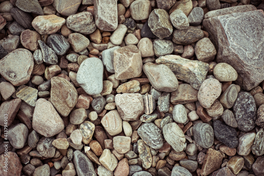 Flat lay birds eye of pretty pebbles and stones on beach Flat lay birds eye of pretty pebbles and stones on beach