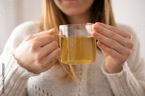 Woman holding a cup of green tea in white background.Relaxing and  healty drink time in a day.