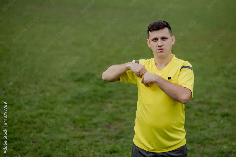 Soccer referee to point out a yellow card to a player in the soccer stadium Soccer referee to point out a yellow card to a player in the soccer stadium