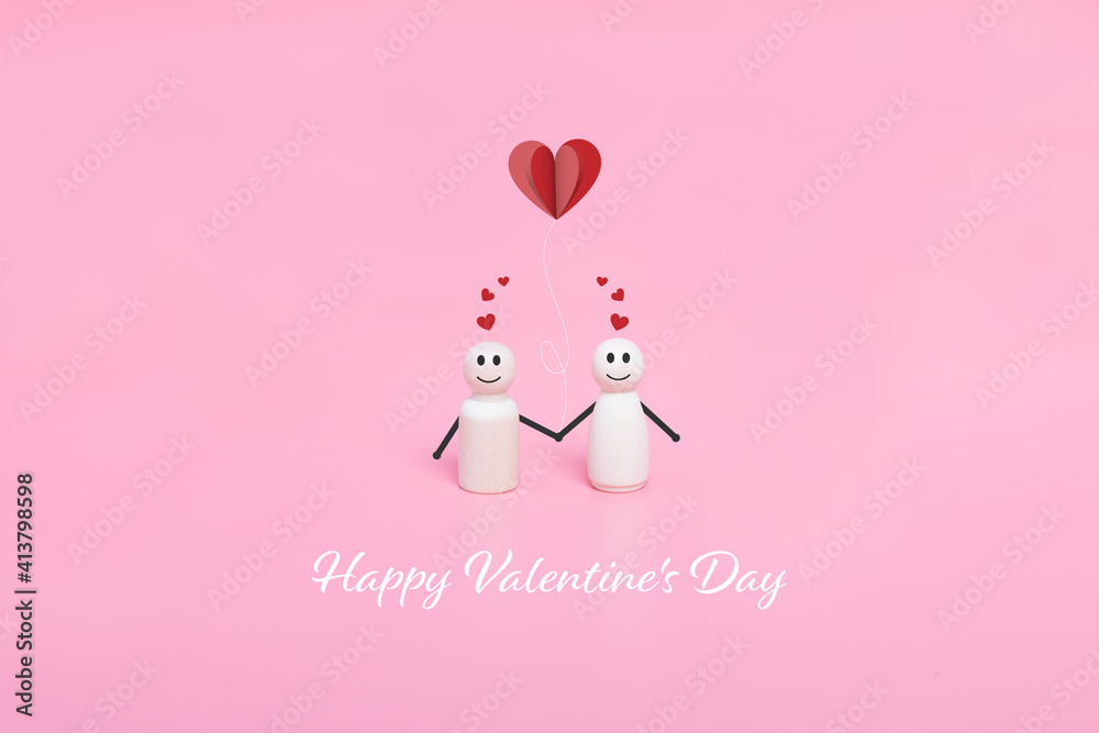 Valentine's day. Couples of wooden doll and hearts shape in pink background.
