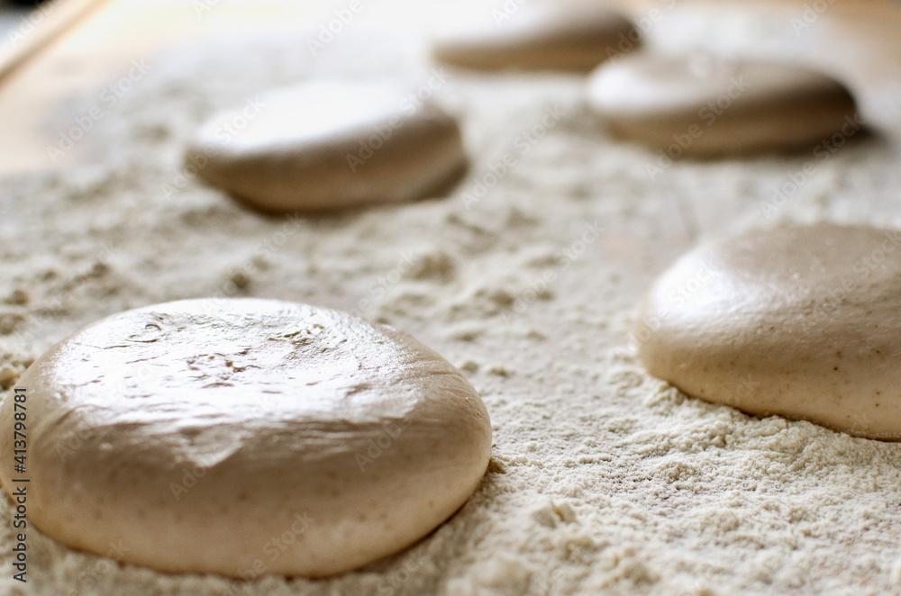 High angle view of pizza dough on flour High angle view of pizza dough on flour