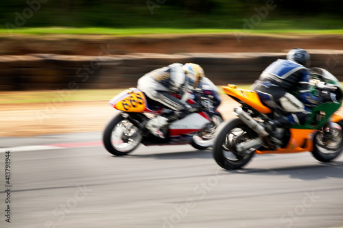 Men driving motorbikes at racing