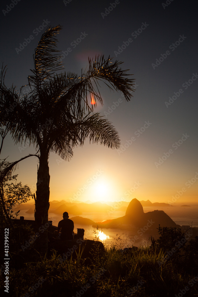 Silhouette of man against Sugarloaf Mountain during sunset Silhouette of man against Sugarloaf Mountain during sunset
