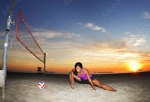 Woman looking away while exercising at beach photo