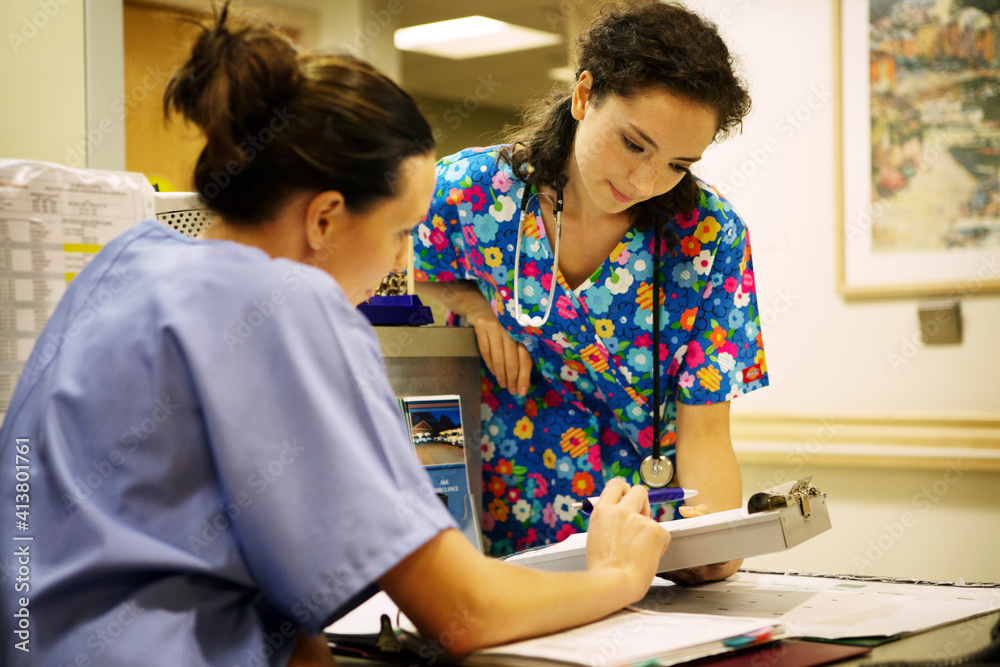 Doctors discussing while working in hospital Doctors discussing while working in hospital