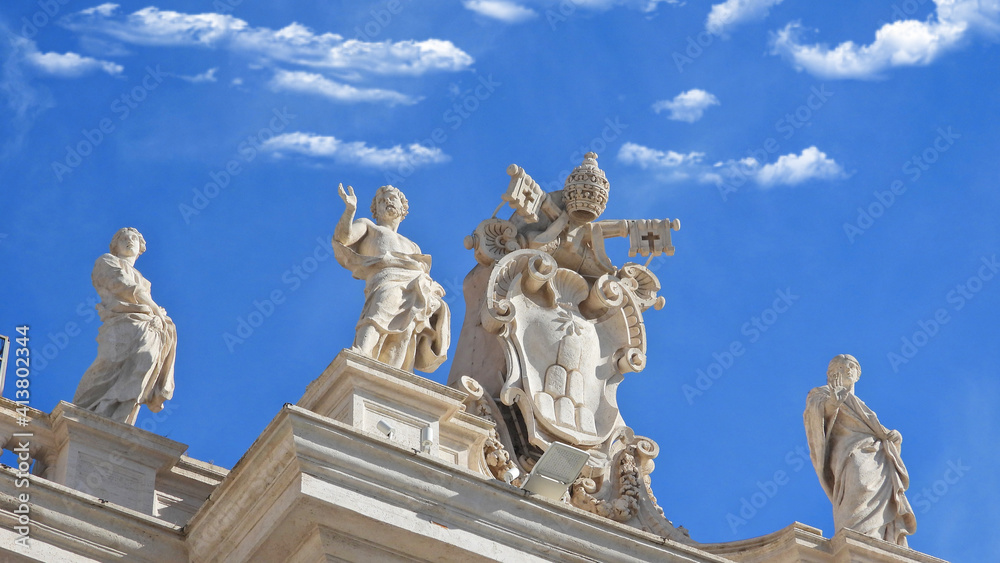 Zoom detail photo of sculptures on top of Saint Peter  basilica in Vatican City, Rome, Italy