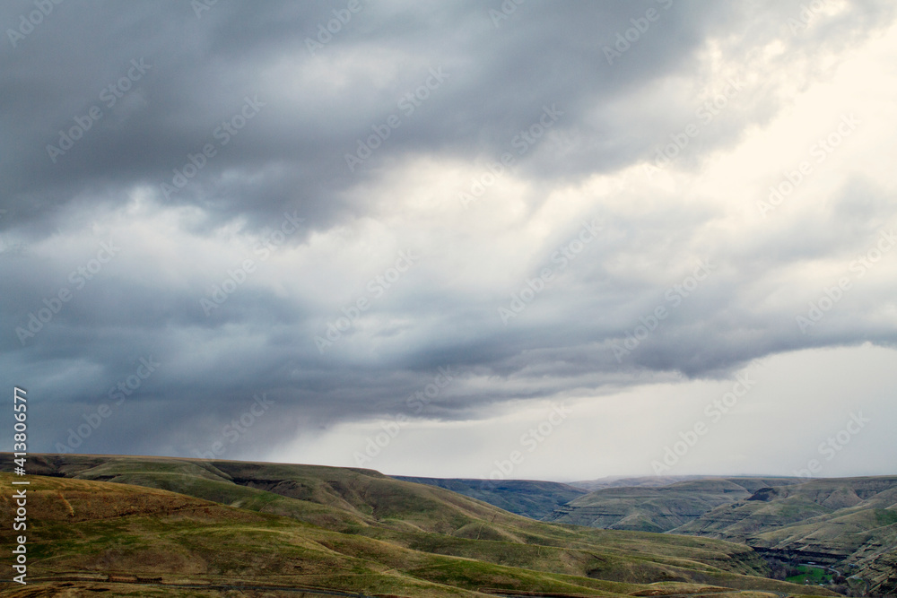Scenic view of landscape against cloudy sky Scenic view of landscape against cloudy sky