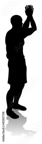 A soccer or football player in silhouette