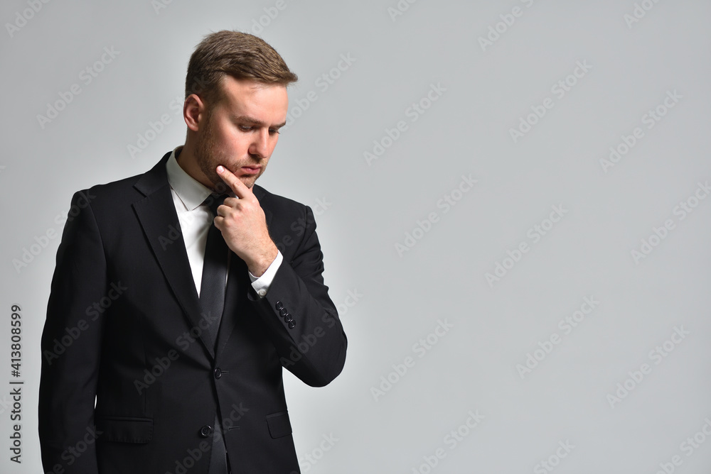 Attractive man in a suit is thinking how to solve a problem Attractive man in a suit is thinking how to solve a problem