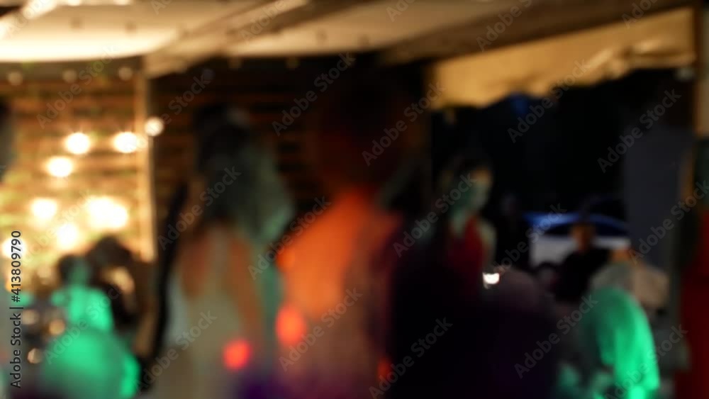 defocus people dance and colorful lights flash, a disco at a party. crowd of people dancing on the dance floor of a night club under the light of colored spotlights and lasers. Blurred silhouettes defocus people dance and colorful lights flash, a disco at a party. crowd of people dancing on the dance floor of a night club under the light of colored spotlights and lasers. Blurred silhouettes