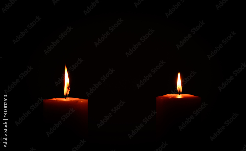 two candles burning in dark two candles burning in dark