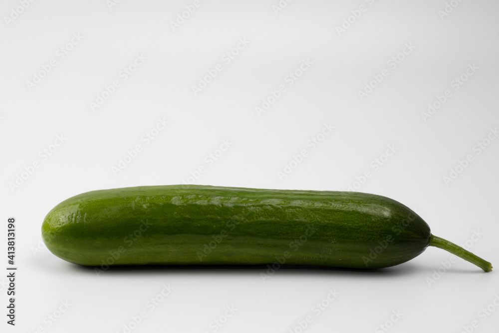 A ripe, green cucumber with stalk on a white background. Space for text A ripe, green cucumber with stalk on a white background. Space for text