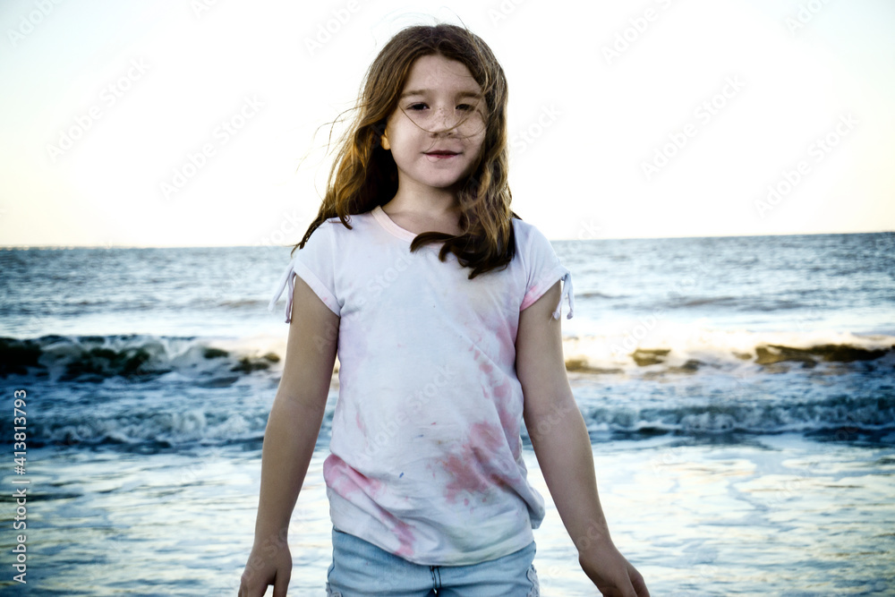 Portrait of cute girl standing against sea Portrait of cute girl standing against sea
