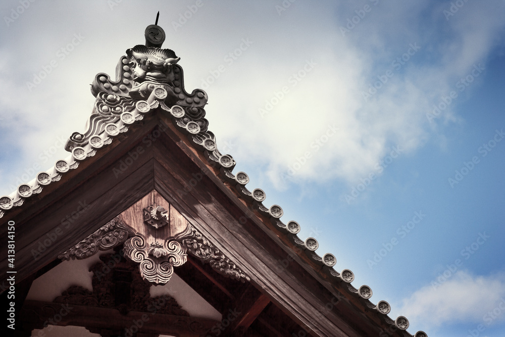 Low angle view of carved roof against cloudy sky Low angle view of carved roof against cloudy sky