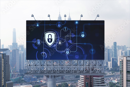 Padlock icon hologram on road billboard over panorama city view of Kuala Lumpur at day time to protect business, Malaysia, Asia. The concept of information security shields.