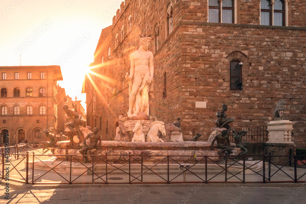 Fountain of Neptune on Piazza della Signoria in the rays of the rising sun in Florence, Italy