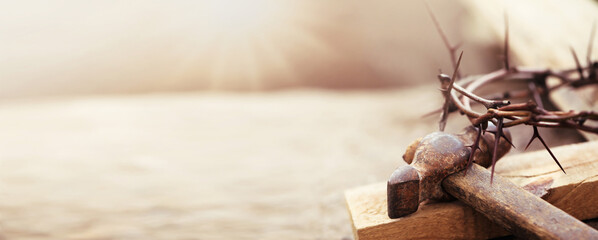 Passion Of Jesus Christ. Crown of thorns, wooden plank and hammer on grey background, banner design