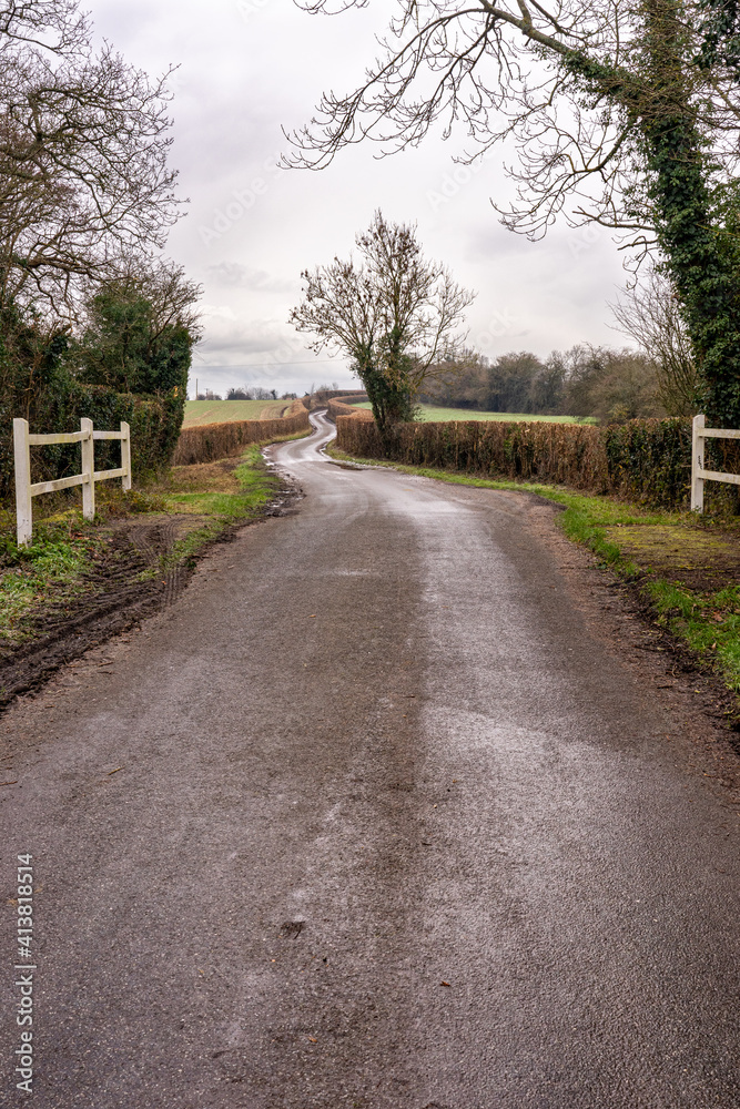 Rural lane twisting through farmland Rural lane twisting through farmland